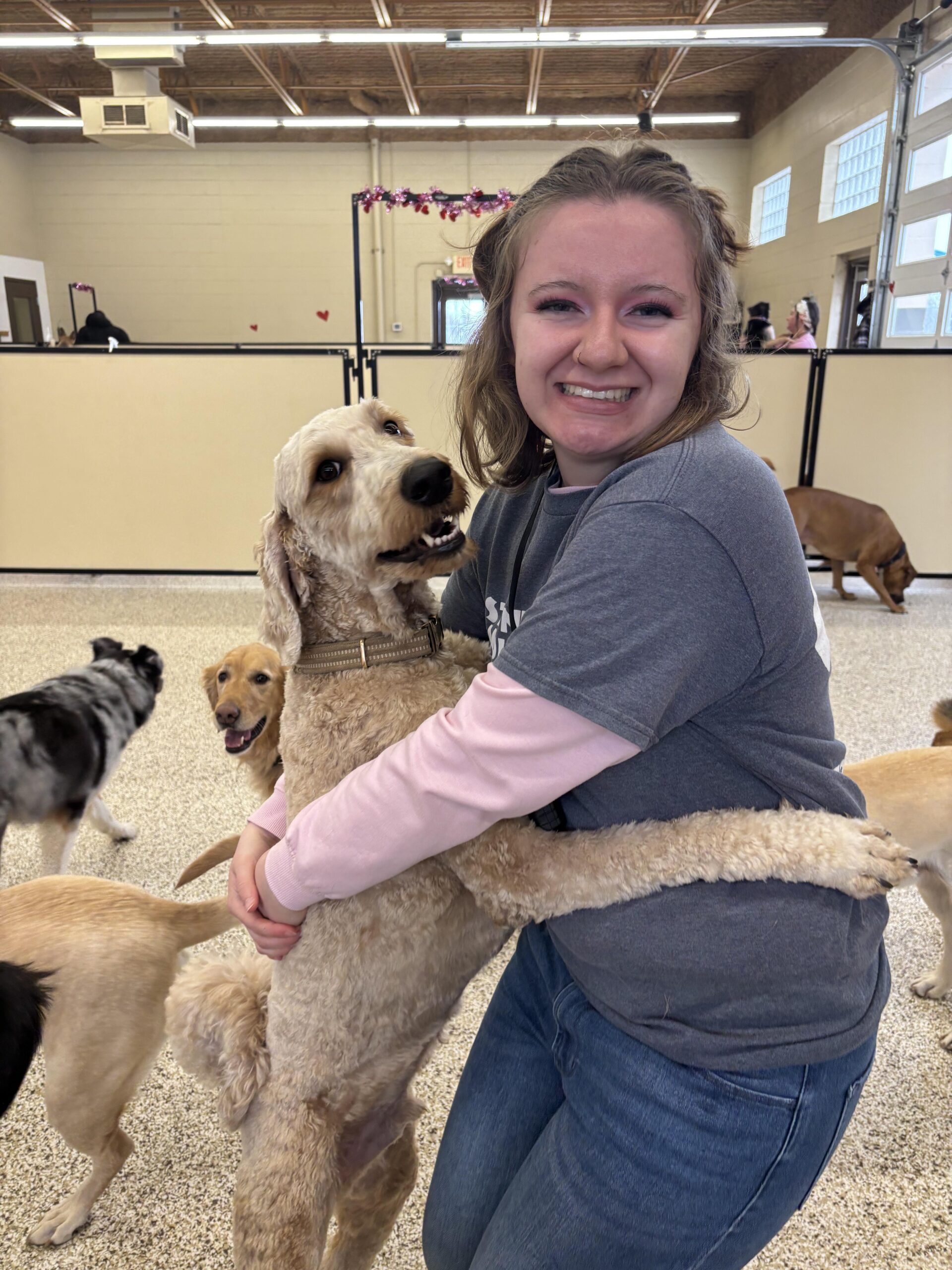Employee hugging doodle dog